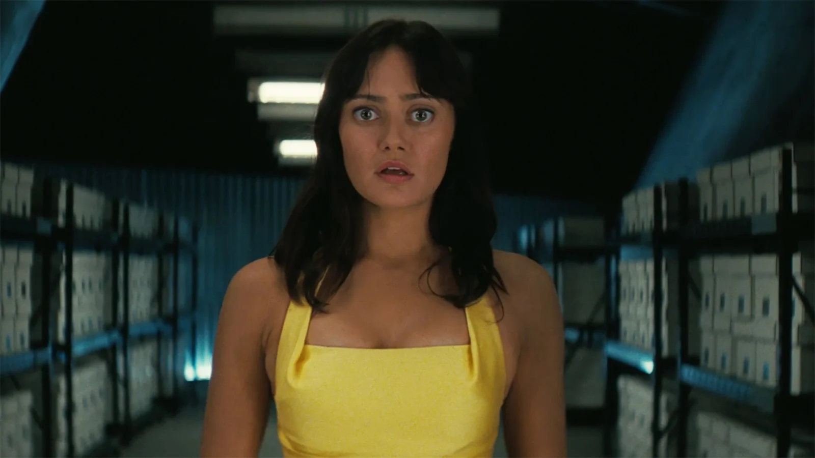 Lucy wearing a yellow dress and looking shocked in Fallout season 2 episode 7